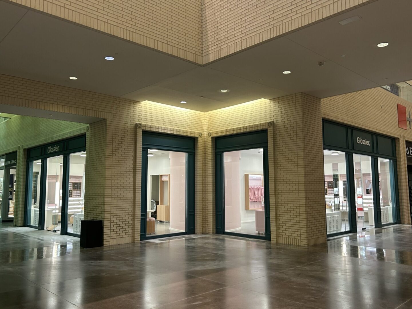 67f6e7a4dd2ea_Image20250409152220 A large empty room with two doors open.